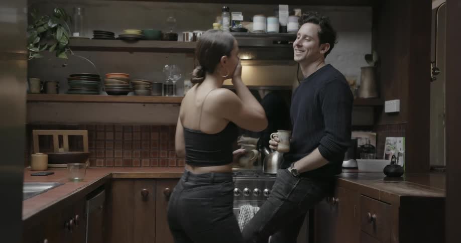 Man and woman talk in the kitchen
