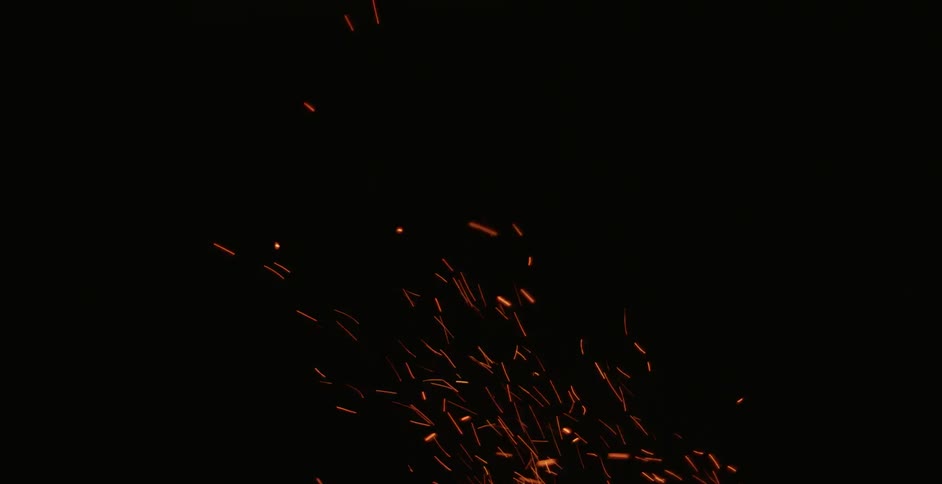 Sparks fly upward in the darkness