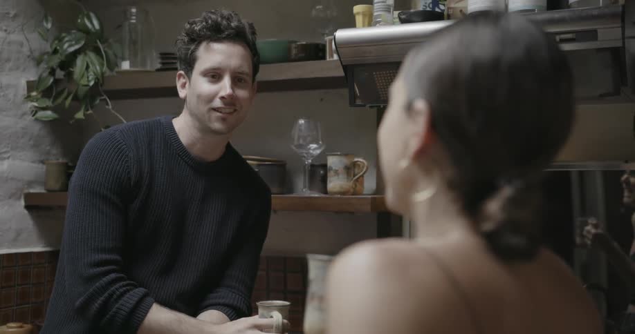 Man and woman talking and smiling in the kitchen