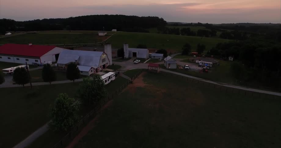 Several barns sit in the middle of a farm