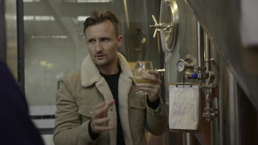 A man checks stills in a distillery