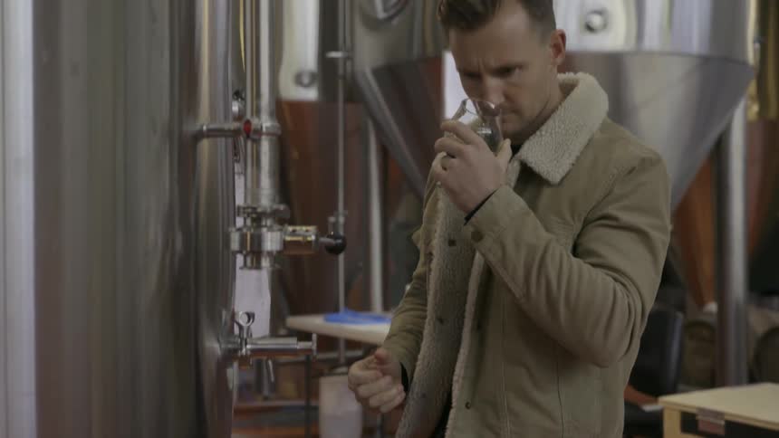 A man pours beer into a glass