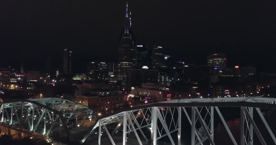 Lights shine on a waterfront city skyline at night