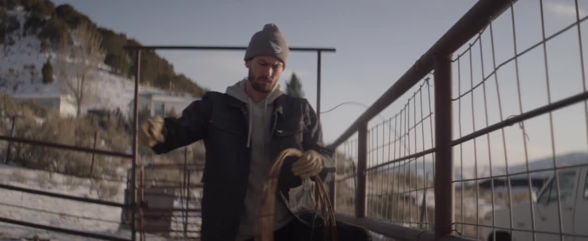 A man is repairing a fence outside