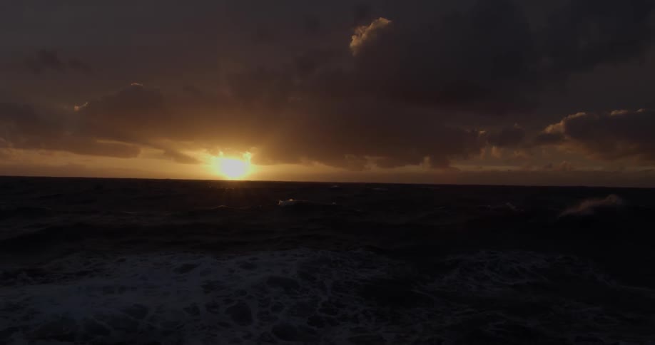 A warming scenic sunset over the ocean from boat