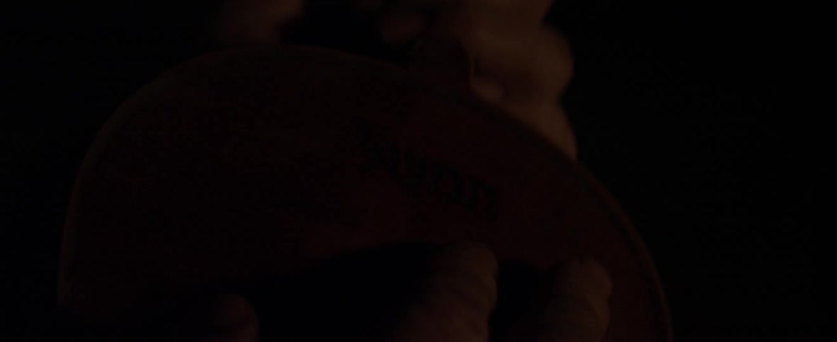 Fingers rub a violin in the dark