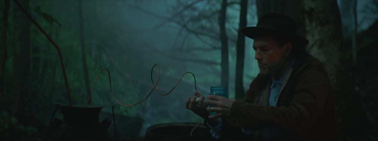 Man opening a jar and tasting the liquid inside
