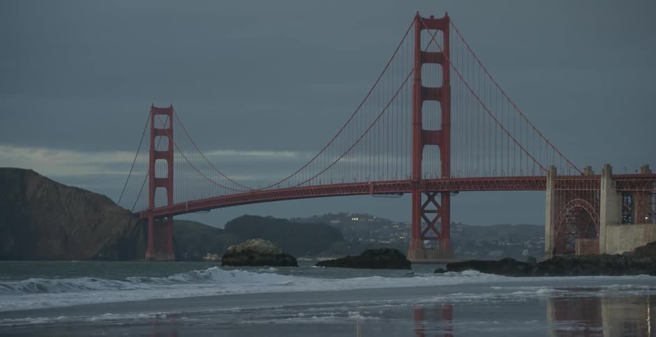 Ocean waves wash ashore near the golden gate bridge