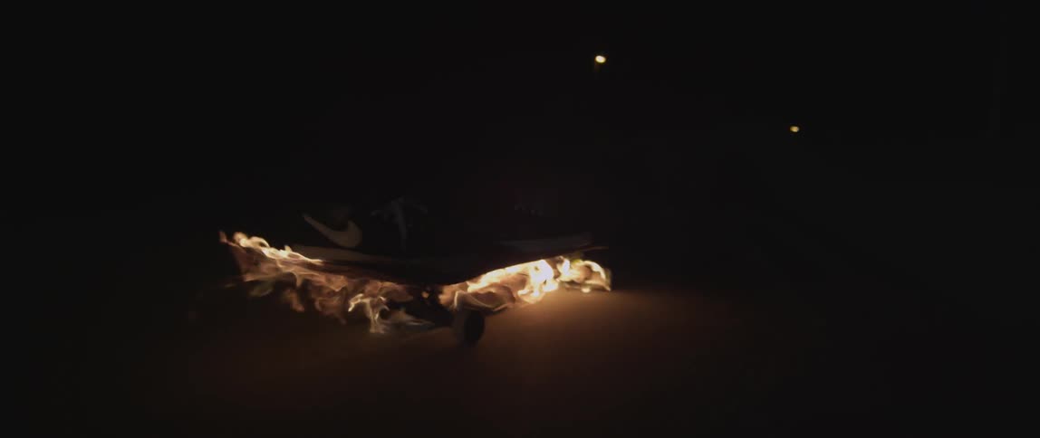 A person is riding a skateboard on fire