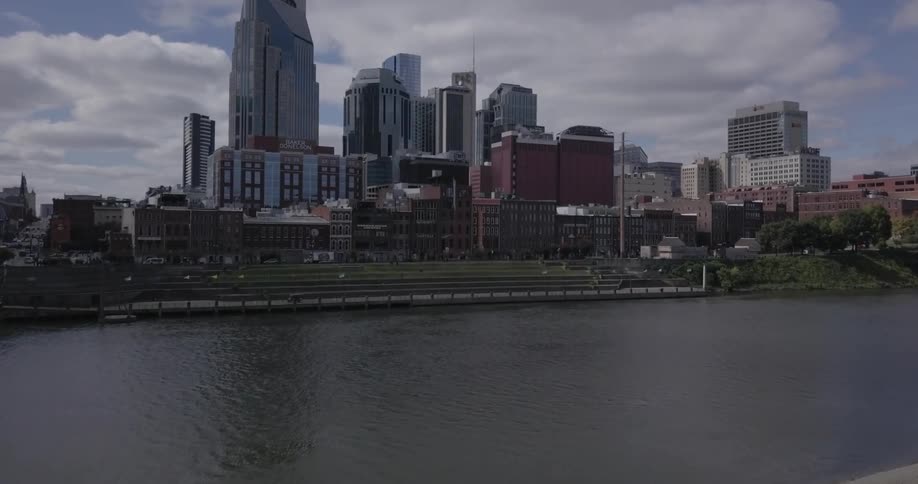 River flows gently in front of a number of tall buildings