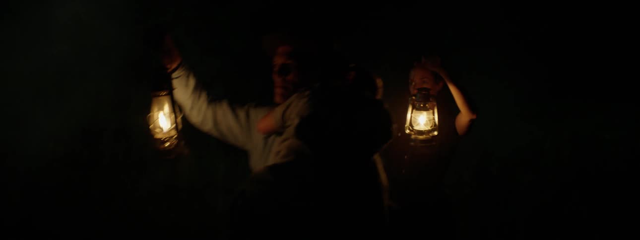 People travel with lamps in a cave