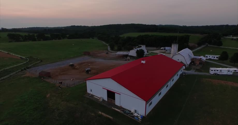 Overhead view of several barns and a field