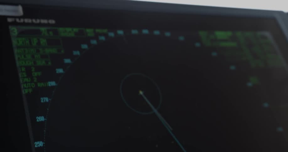 A computer screen shows ocean radar on ship