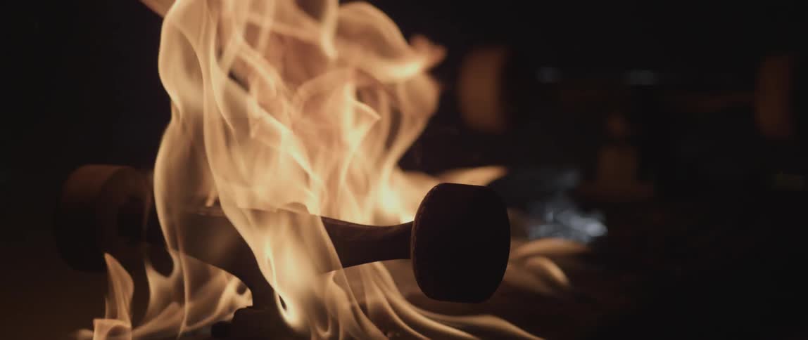 A close up shot of a skateboard on fire