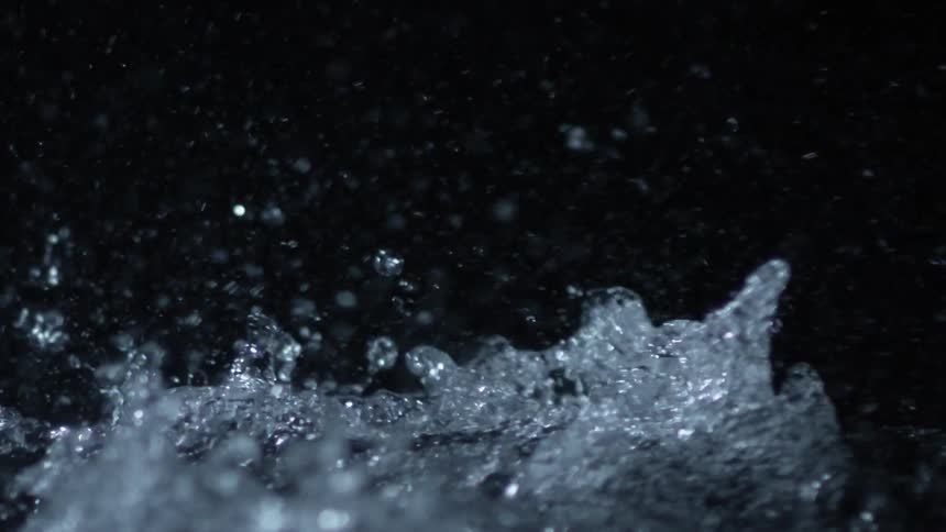 Water splashing in a dim room