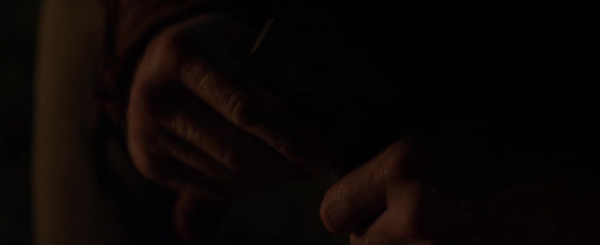 Person's hands in dim light