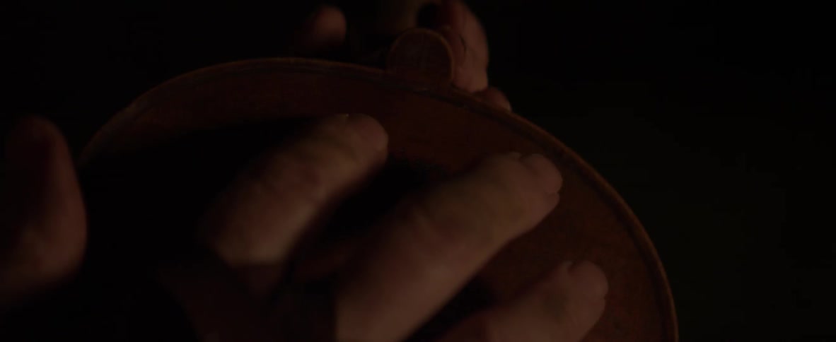 A person traces their fingers on an instrument