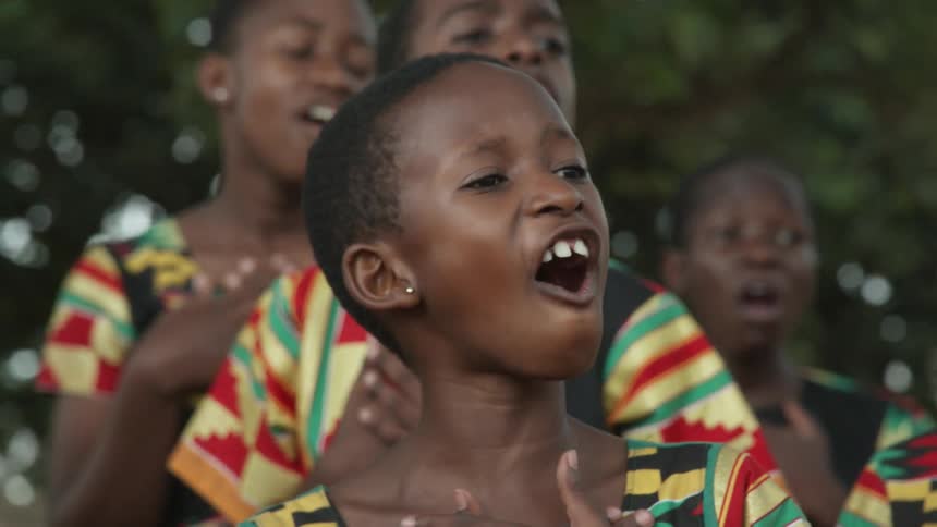 Children sing together outside