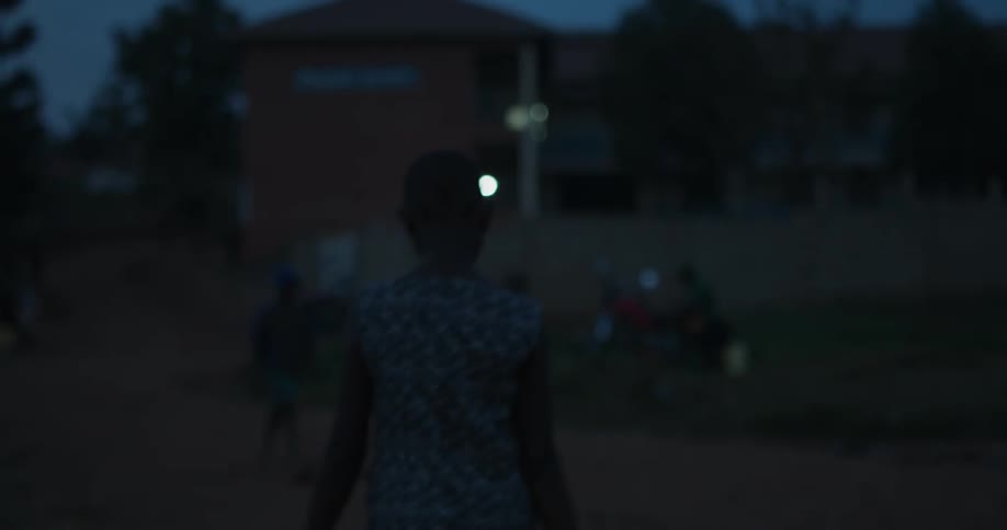 People walking down the road at dusk