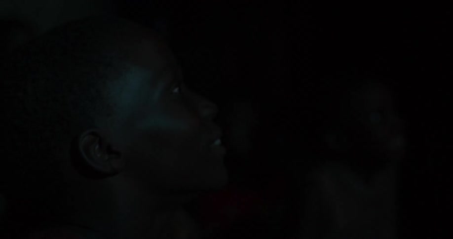 Children smile as they watch something