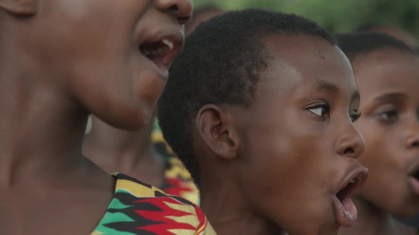 Group of children smile and sing