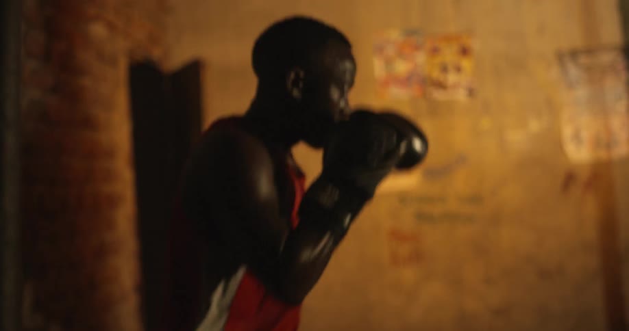 Man wearing boxing gloves practices his jabs