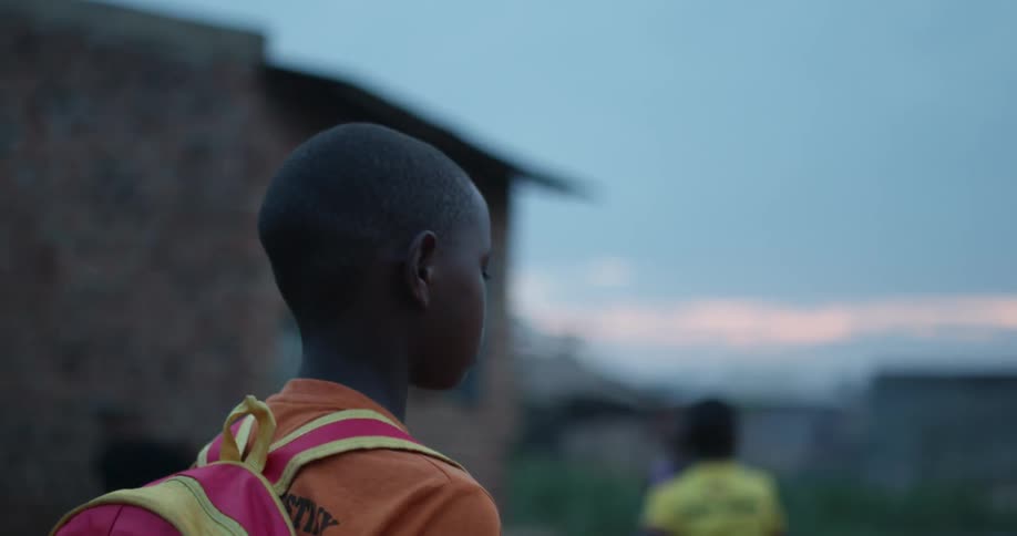 Sad looking child walks in a village