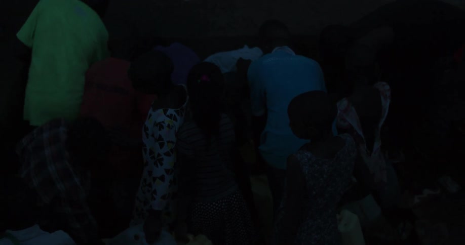 Group of people walking in dim light