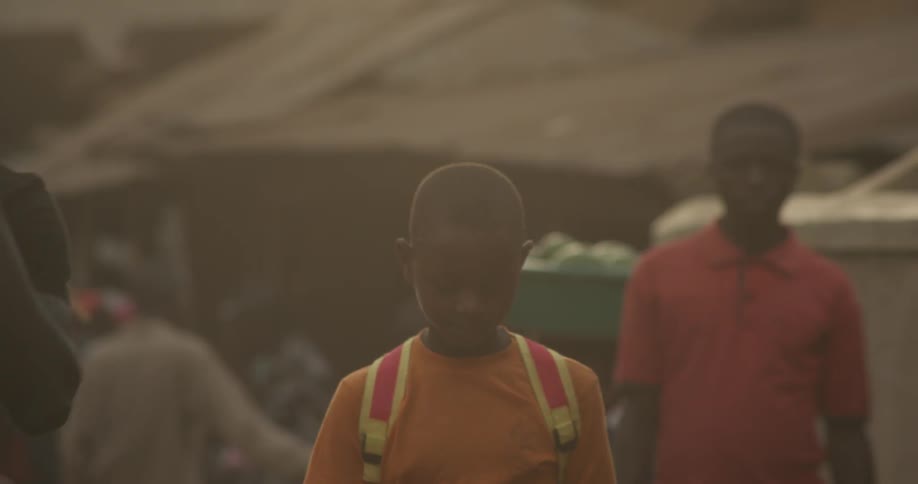 Group of children walking in a dusty village