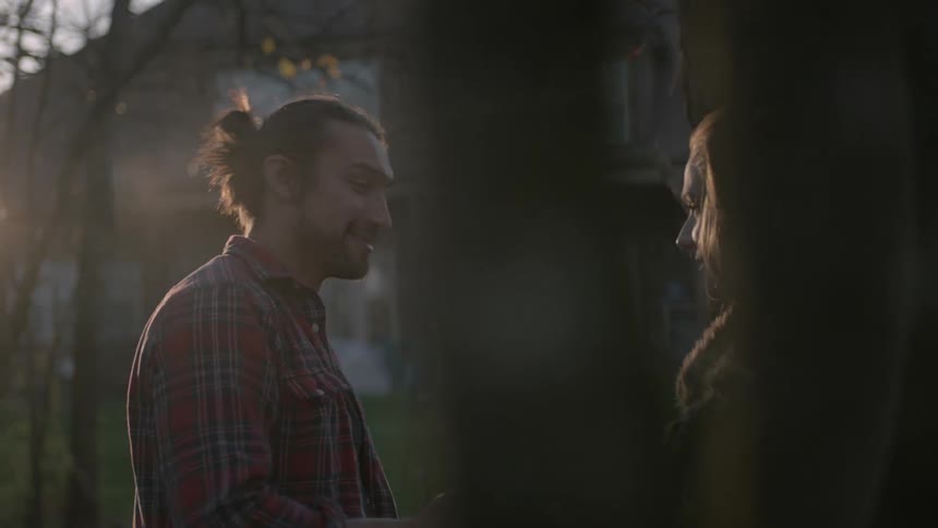 Man and woman playing a game as the sun sets