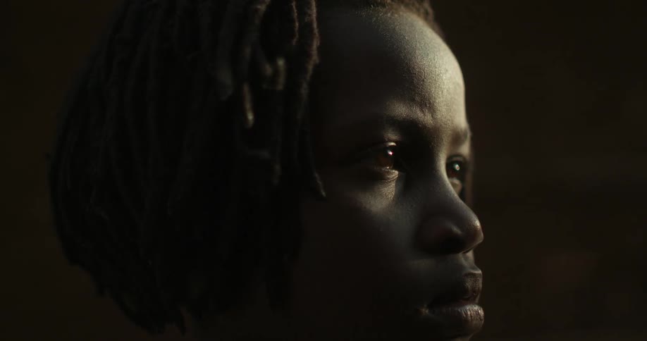 Concerned looking woman stares in dim light