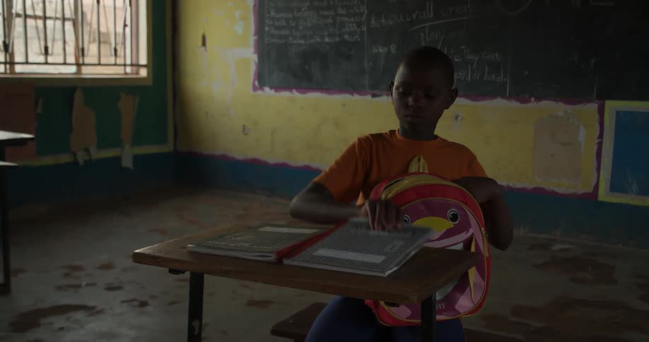 A child removes books from her backpack