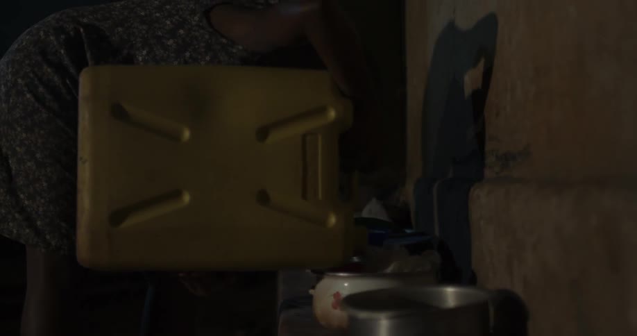 A person pours liquid into a pan