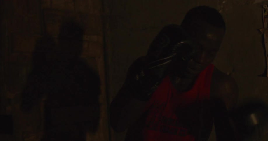 Boxer in a red jersey practices his jabs