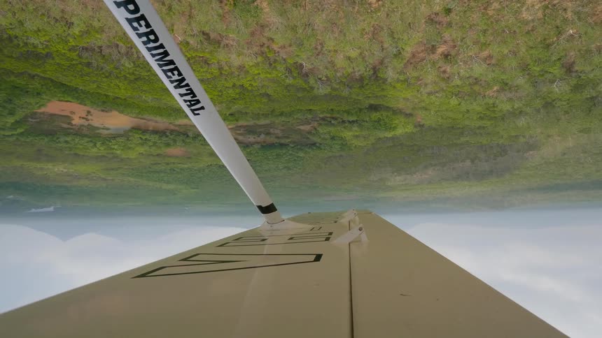 An experimental plane is flying upside down