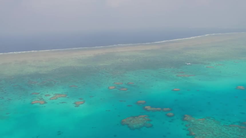 Crystal clue blue water is being filmed from the air