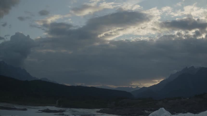Clouds hang over hills on winter day
