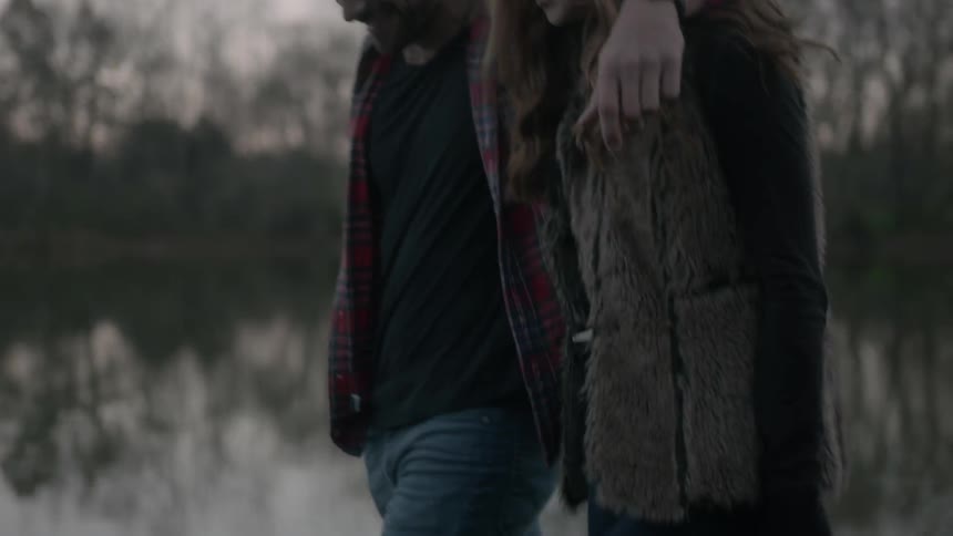 A man and woman holding hands and walking together