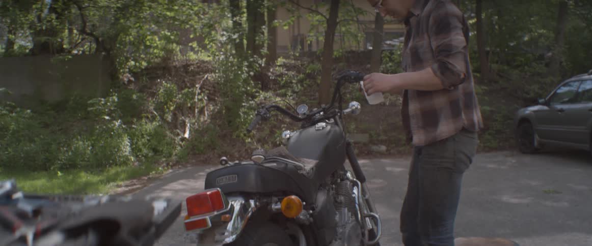 A man is working on his motorcycle