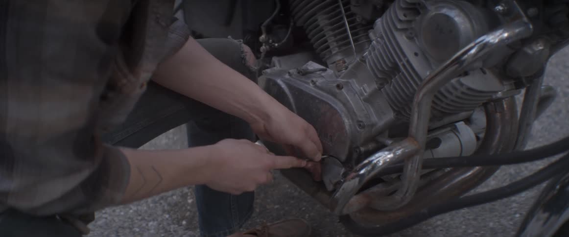 A man is working on the engine of his motorcycle