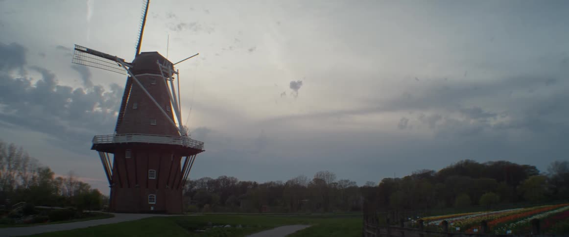 A windmill is being illuminated by the sun