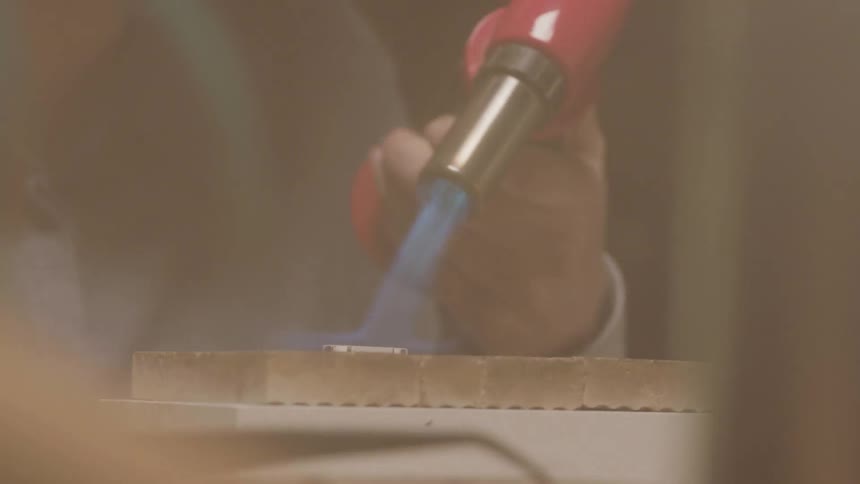 A person uses a blowtorch
