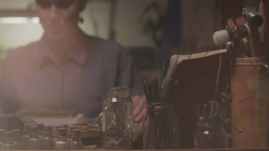 A woman is working on something in her shop