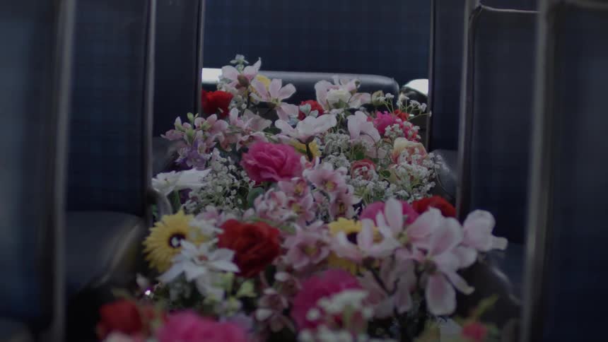 Walkway aisle inside bus between seats full of variety of flowers