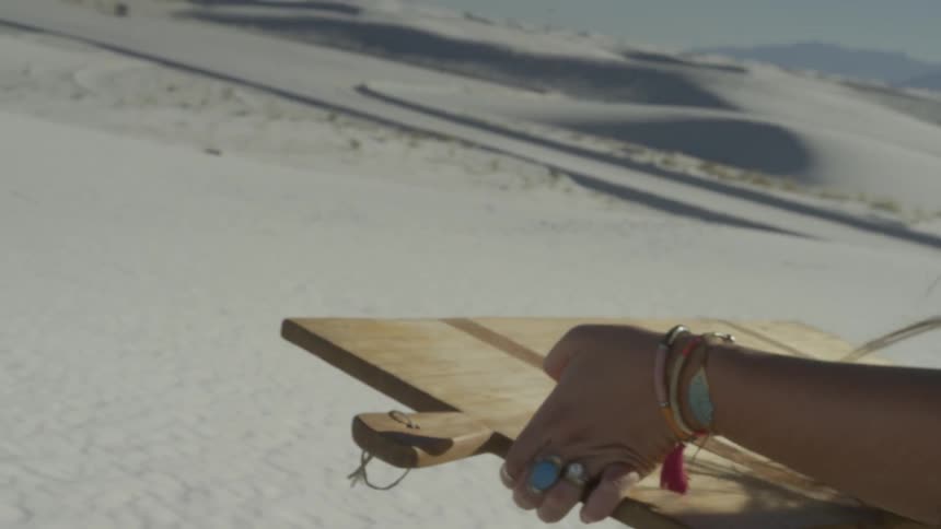 A person picks up a wooden board