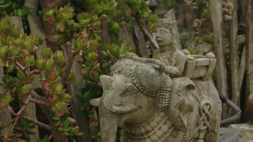 An old stone carving of a man riding an elephant