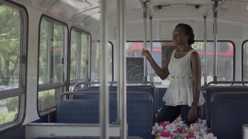A woman is waiting on the bus