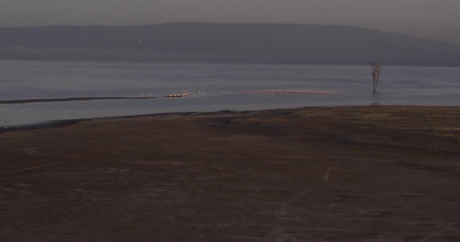 A desert landscape gives way to a river being filmed from the air