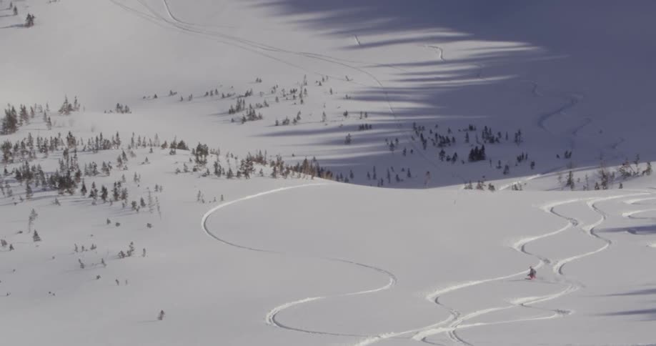 A skier rides down a snowy mountain
