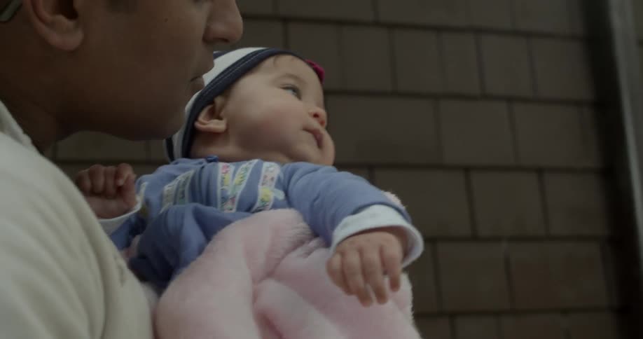 A man holds a baby girl